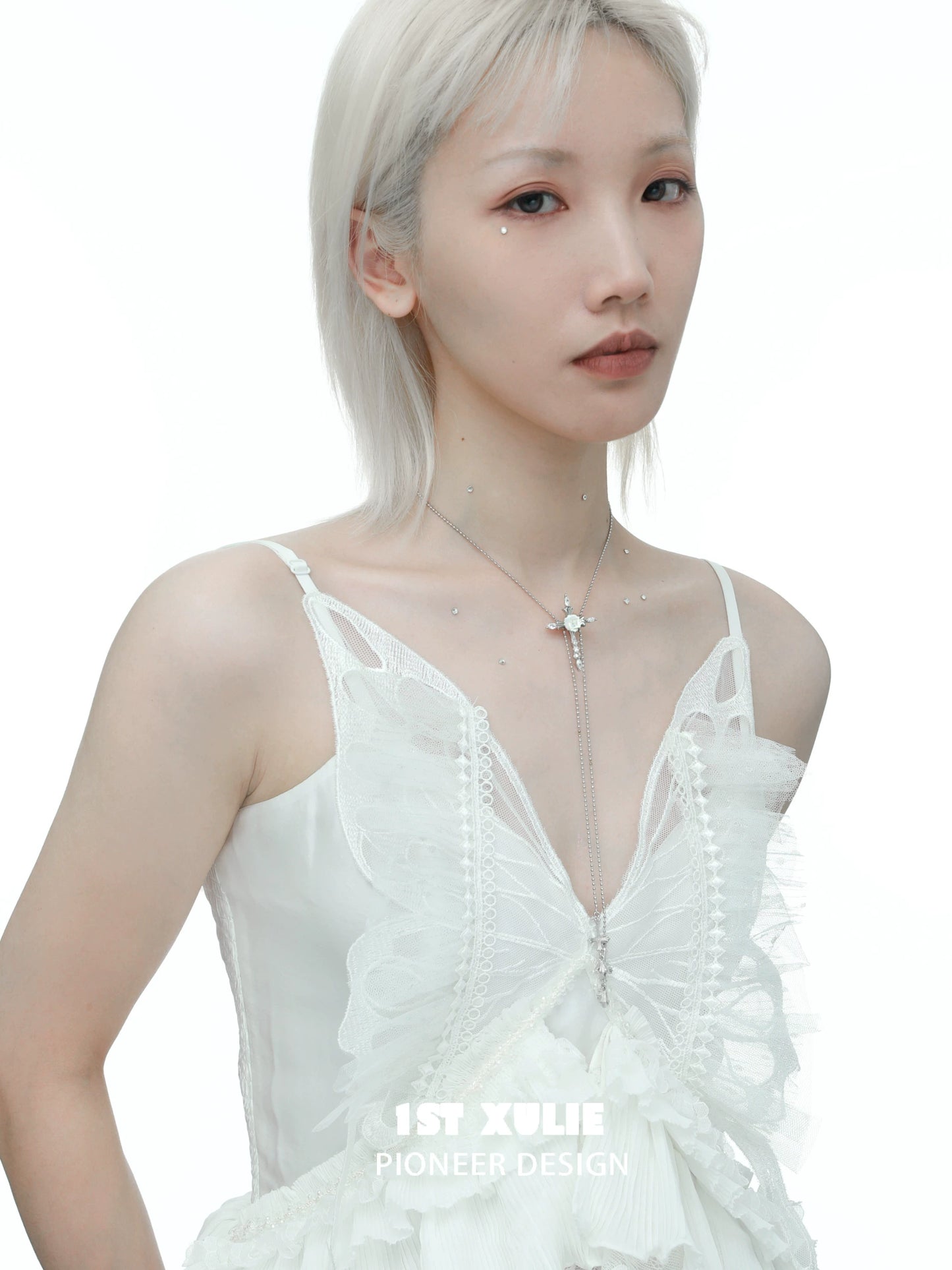 Elegant rose cross necklace from 1STXULIE worn by a model in a bridal dress