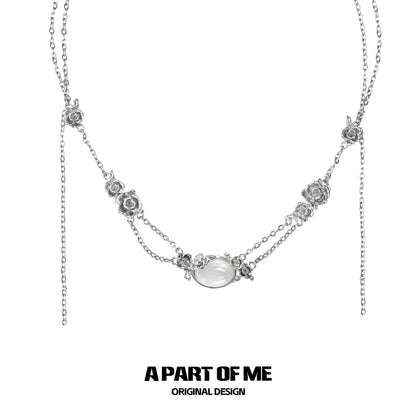 Elegant rose silver necklace with floral accents and a central gemstone design