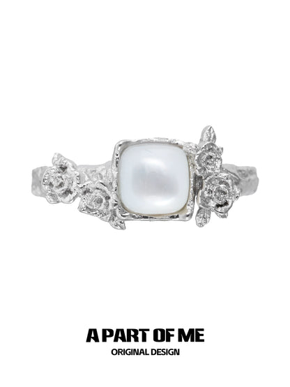 A PART OF ME rose silver ring featuring a central pearl and floral design details