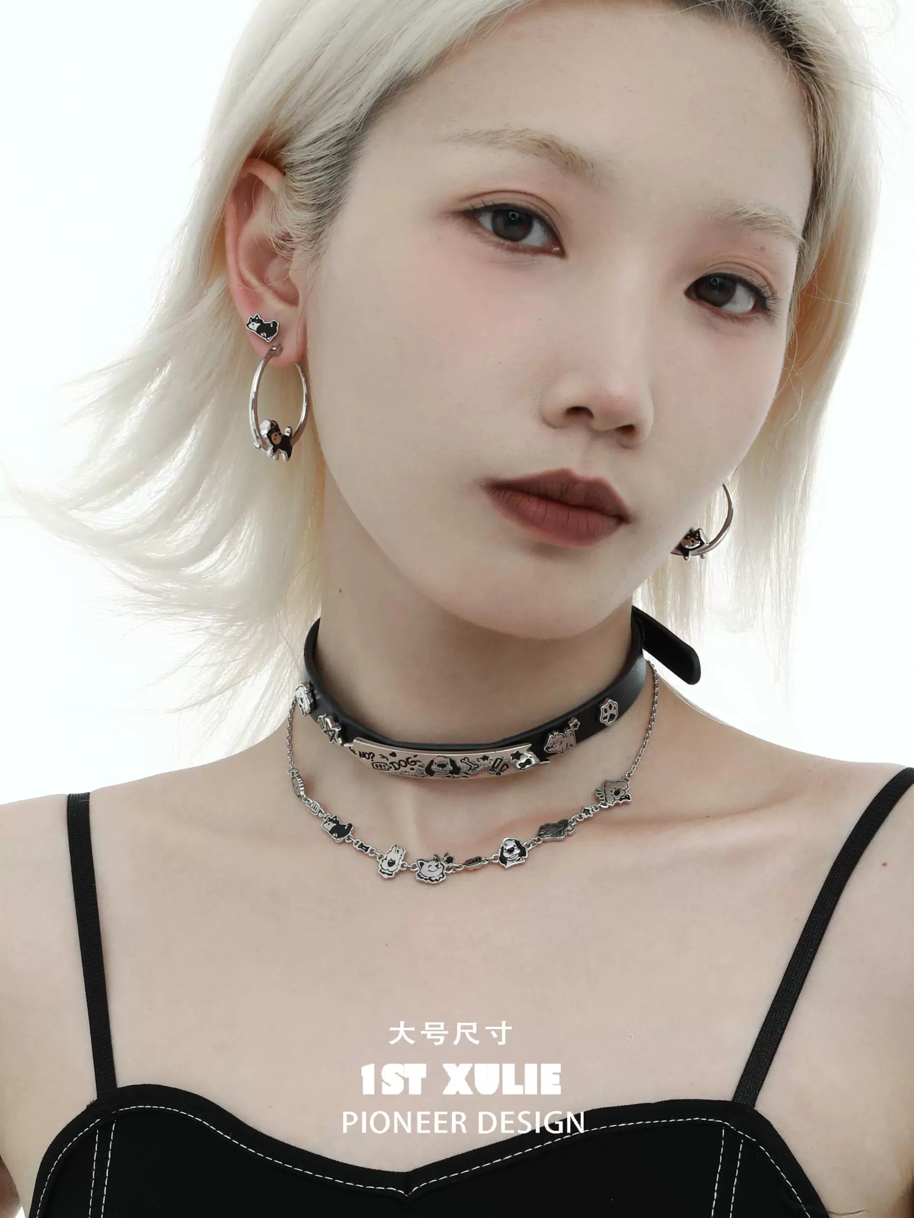 Stylish model wearing running puppy earrings with silver details and a choker necklace