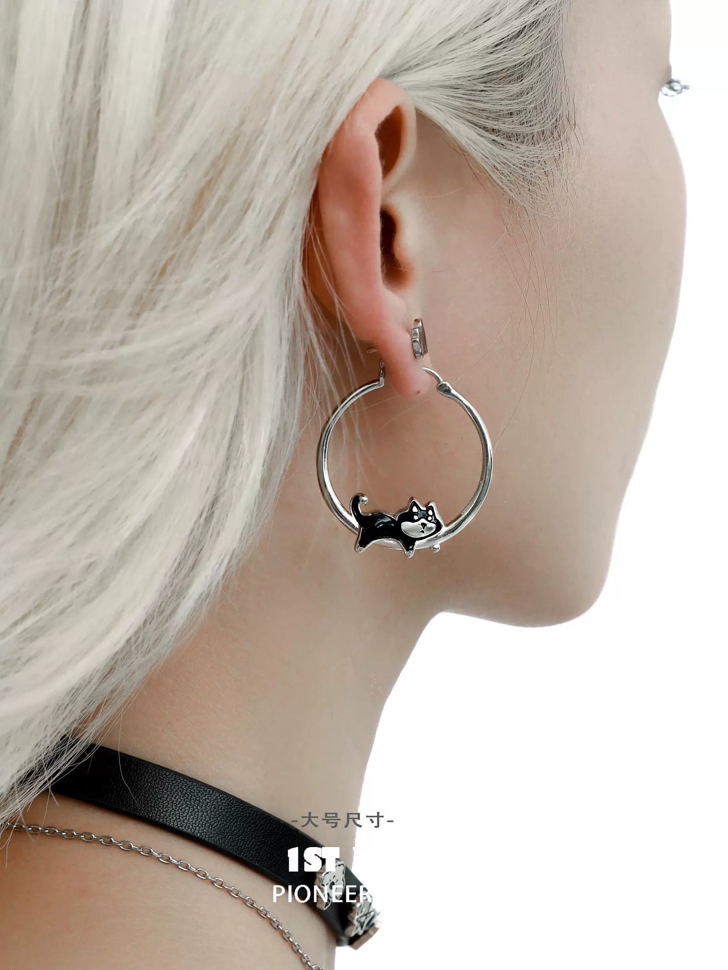 Cute running puppy earrings on a model, featuring silver hoops and playful puppy designs
