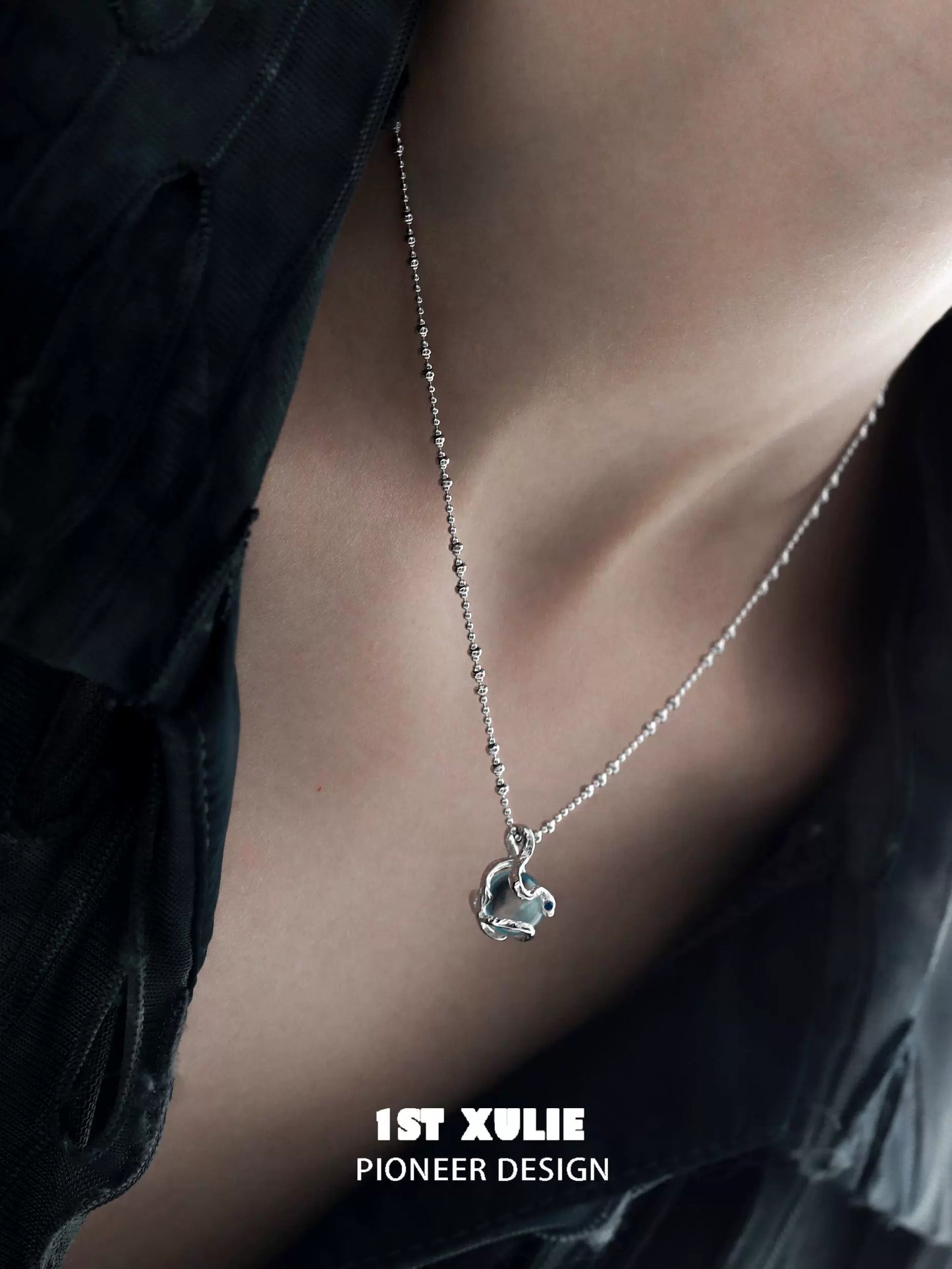 Serpent silver necklace on a model, showcasing intricate design and elegance for everyday wear