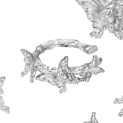 Elegant silver butterfly ear cuff featuring intricate butterfly designs and a stylish wrap-around style