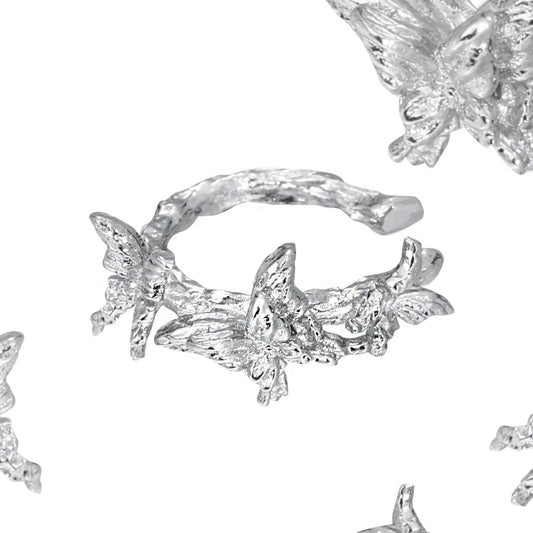 Elegant silver butterfly ear cuff featuring intricate butterfly designs and a stylish wrap-around style