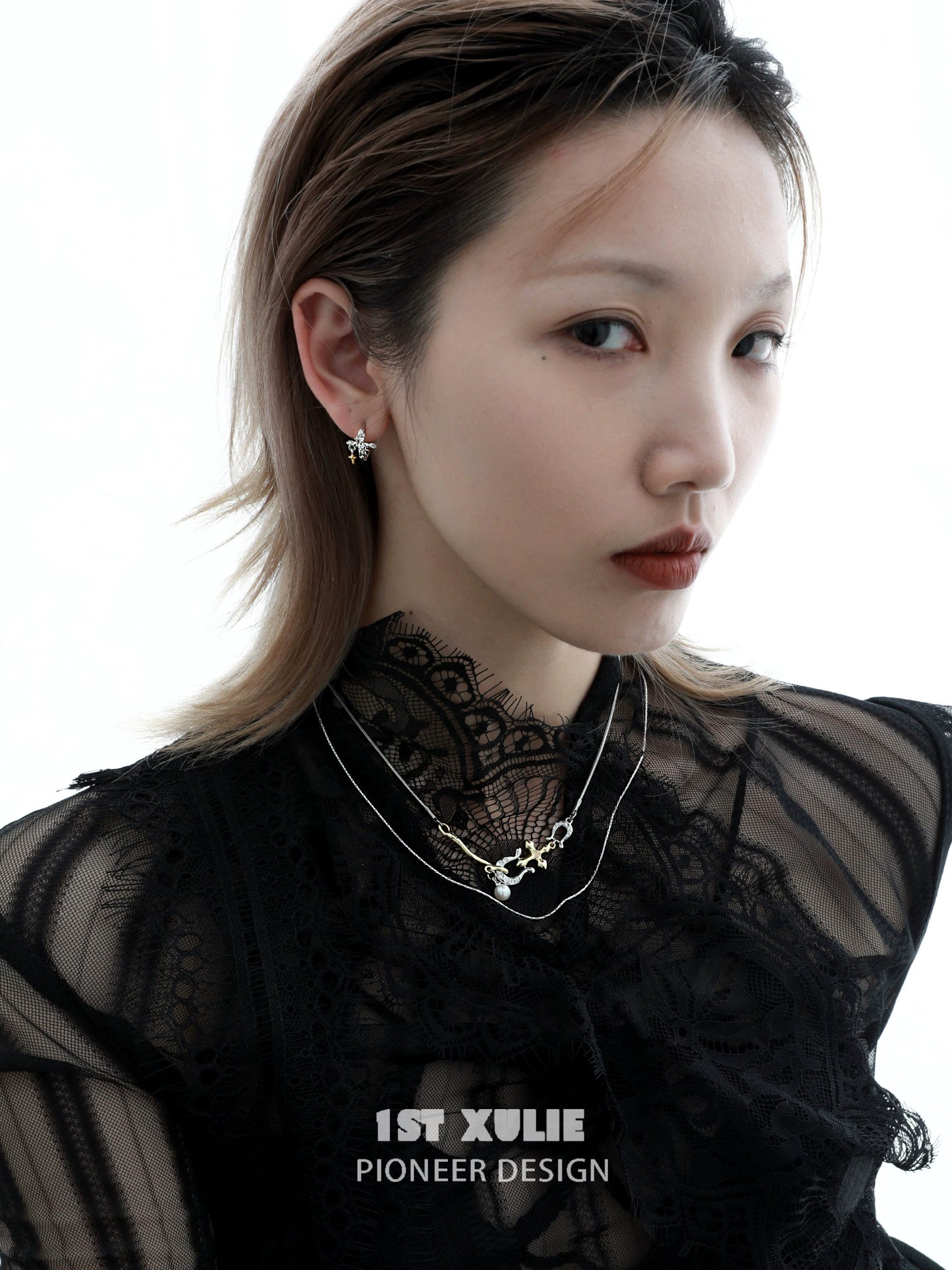 Stylish model wearing silver cross ear clips paired with layered necklaces for a chic look