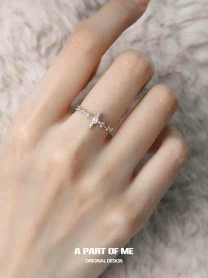 Delicate silver cross ring by A PART OF ME with intricate detailing on a model's hand