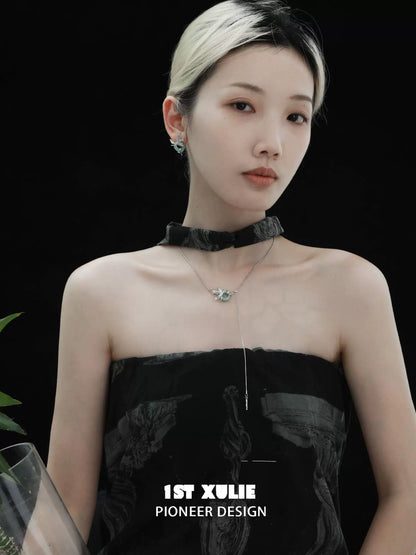 Elegant silver iris pull buckle necklace showcased on a model with a chic black outfit