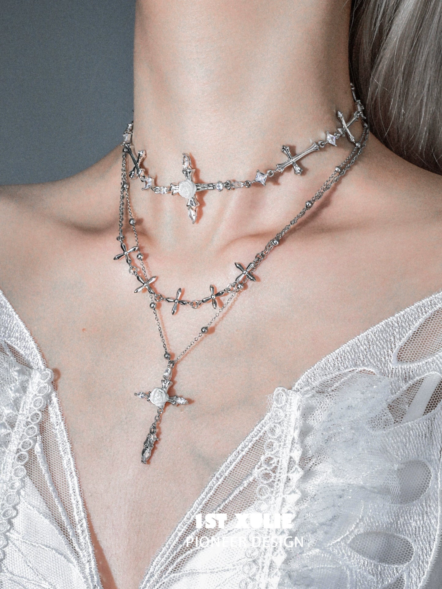 Elegant silver rose cross necklace layered with intricate cross designs and sparkling accents