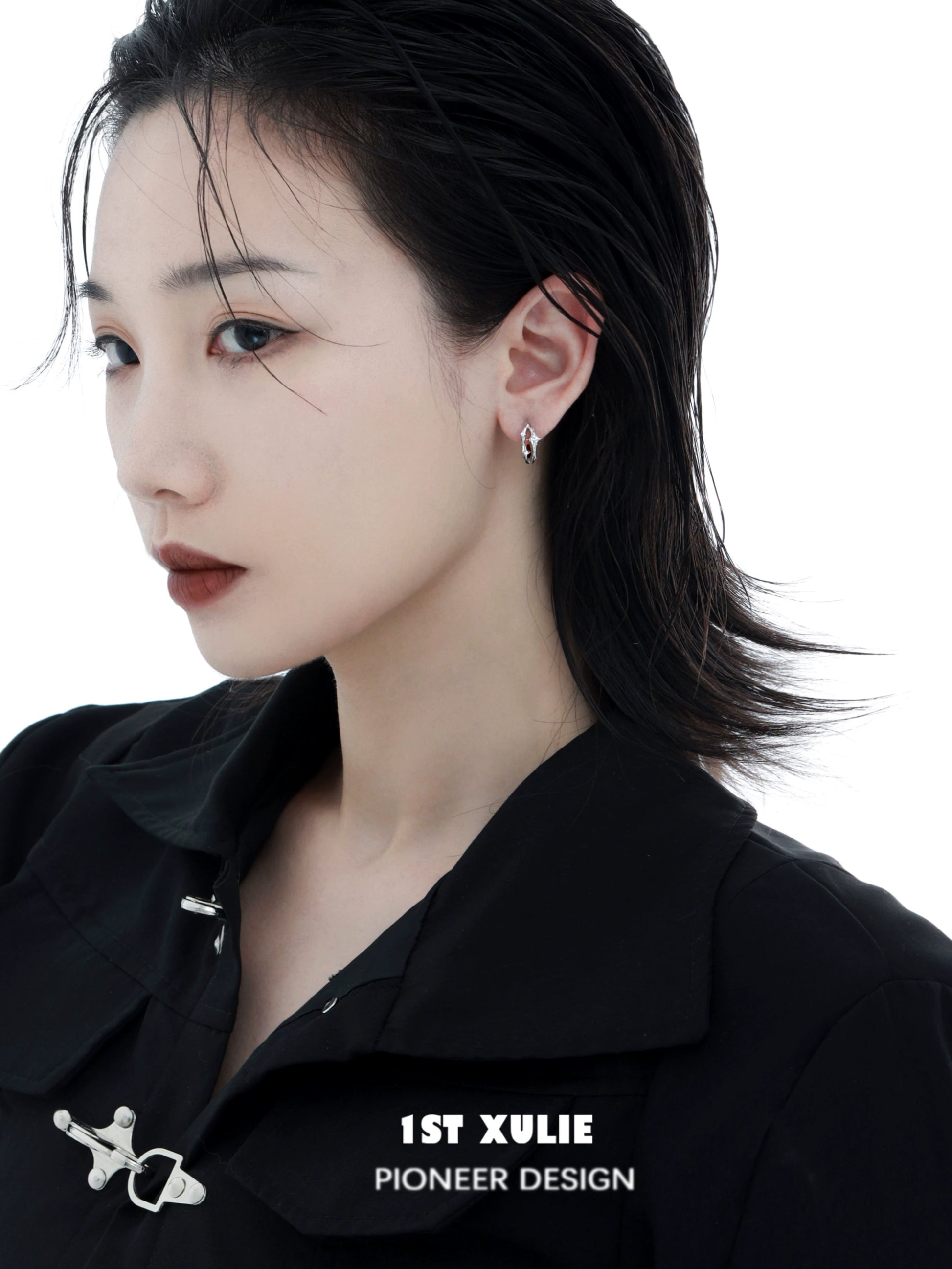 Model wearing a silver star ear cuff from 1ST XULIE, showcasing elegant design and modern style