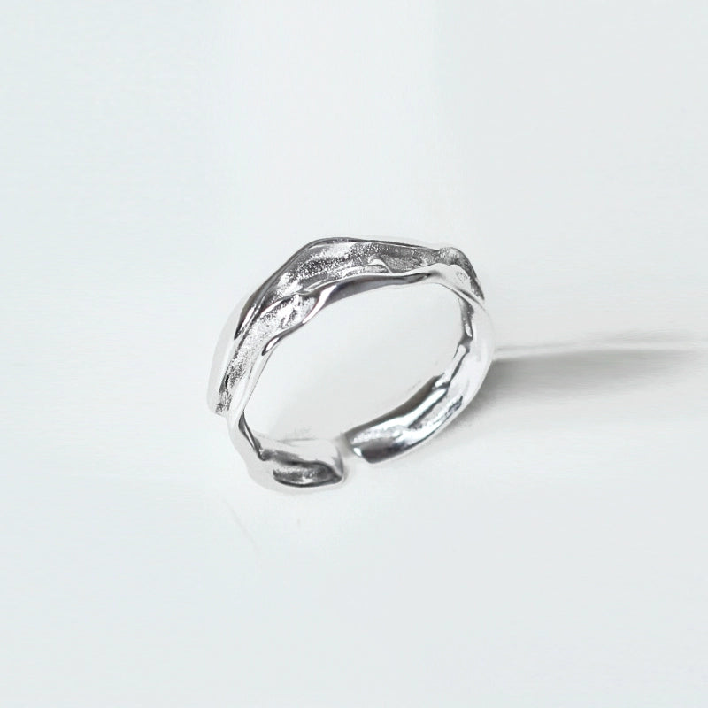 Artistic silver statement ring showcasing a unique textured design for bold fashion statements
