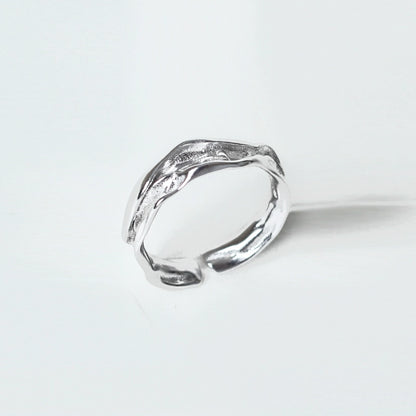 Artistic silver statement ring showcasing a unique textured design for bold fashion statements