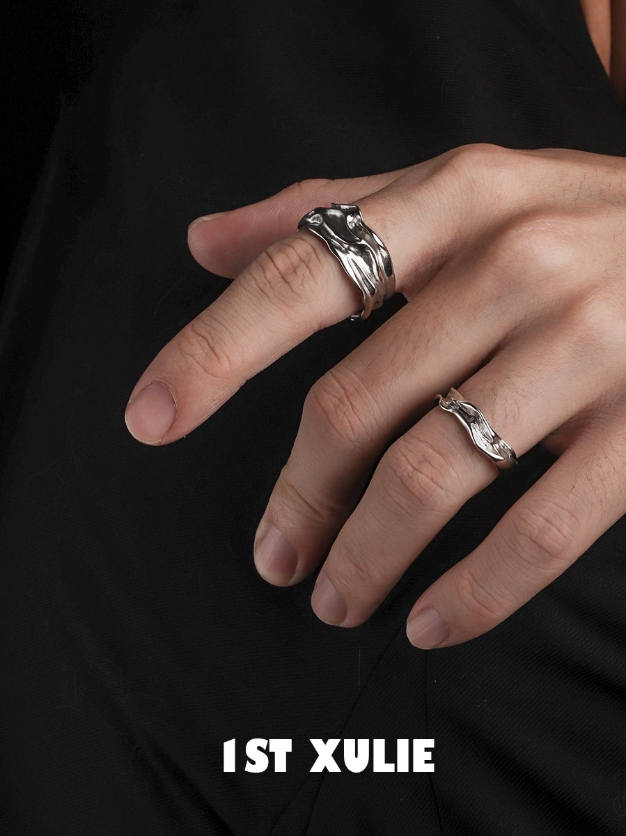 Elegant silver statement ring displayed on fingers, showcasing a unique wave design for stylish accessorizing
