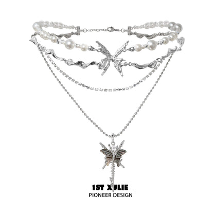 Layered skeleton butterfly pearl necklace with silver chains and detailed butterfly pendant