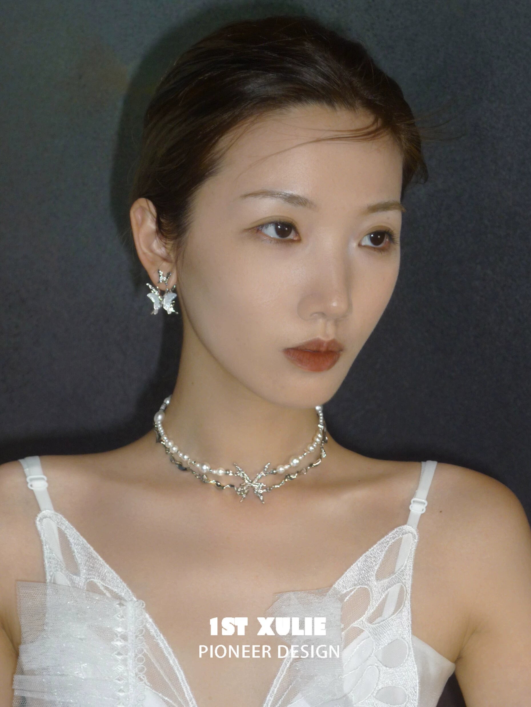 Elegant skeleton butterfly pearl necklace by 1STXULIE, adorned with shimmering pearls and butterfly accents