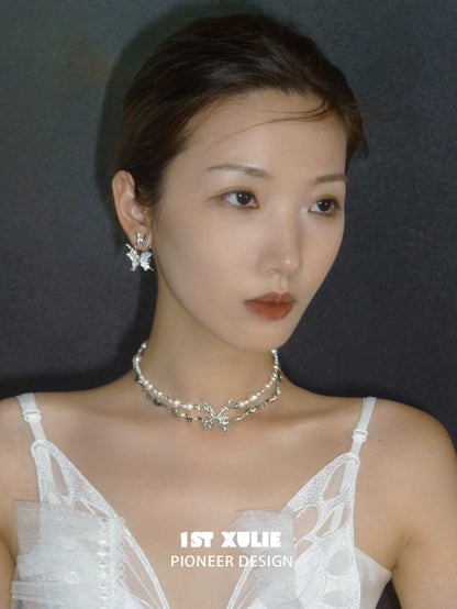 Elegant skeleton butterfly pearl necklace by 1STXULIE, adorned with shimmering pearls and butterfly accents