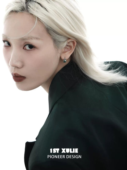 Model wearing Slytherin fang earrings showcasing a sleek design and elegant style