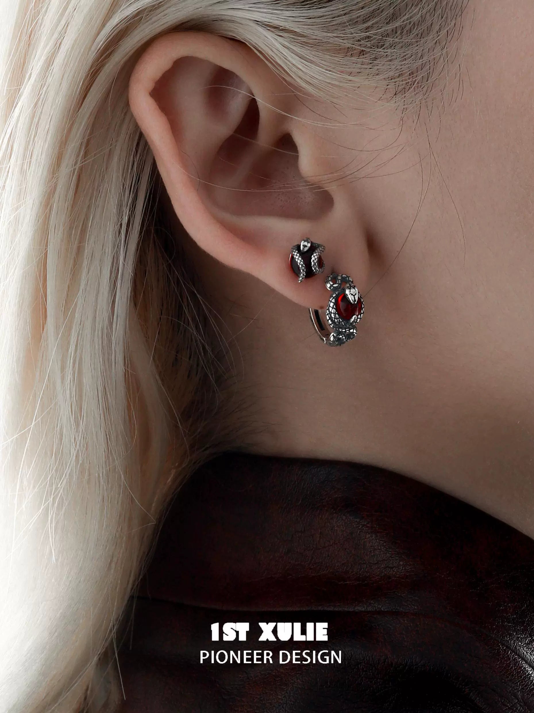 Stylish Slytherin fang earrings featuring intricate design and red accents for a bold look