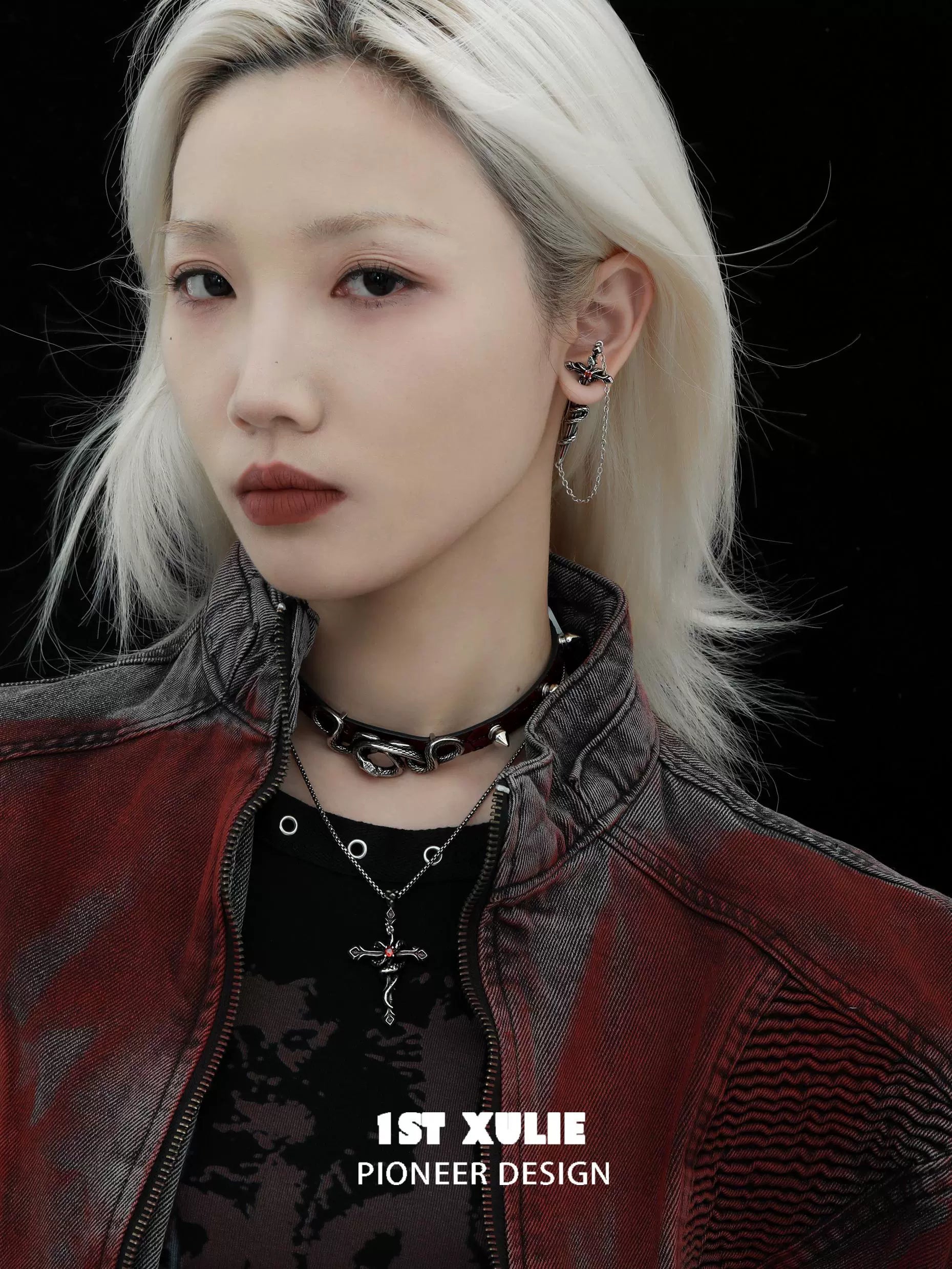 Model showcasing Slytherin snake earrings with a punk aesthetic and stylish outfit