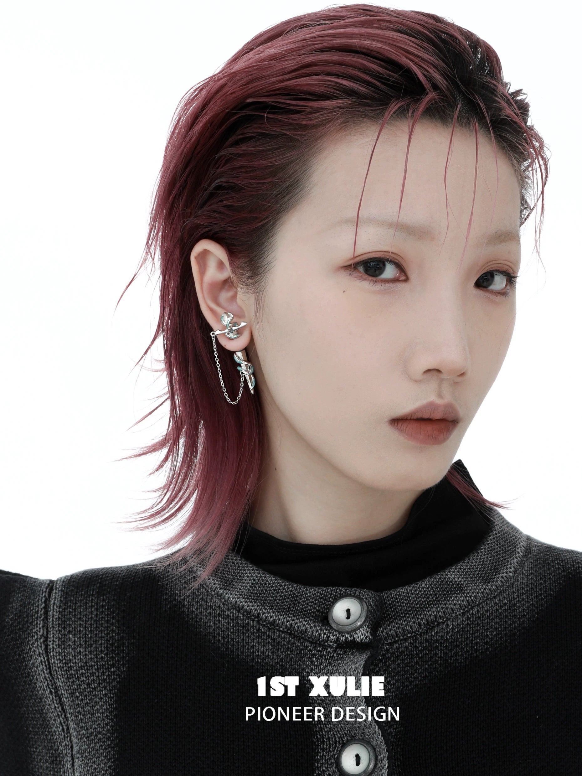 Stylish model wearing 1STXULIE snake chain piercing earrings with a modern design