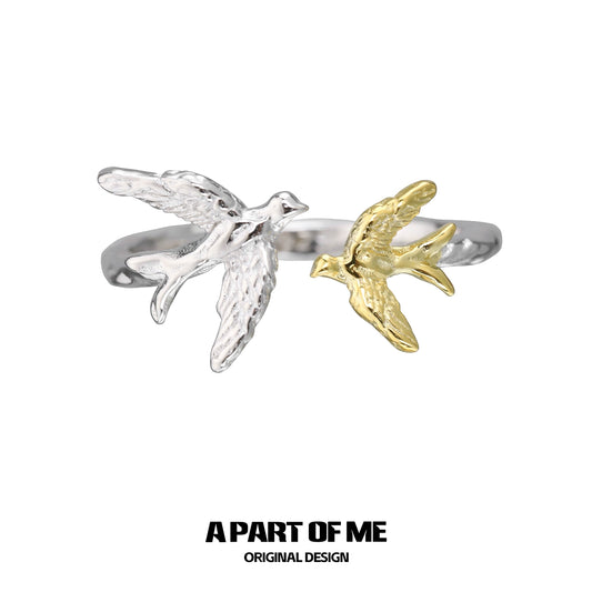 A PART OF ME soaring birds ring featuring a silver and gold bird design for unique jewelry lovers