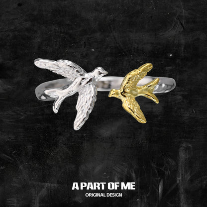 A PART OF ME soaring birds ring featuring a silver and gold bird design for unique style
