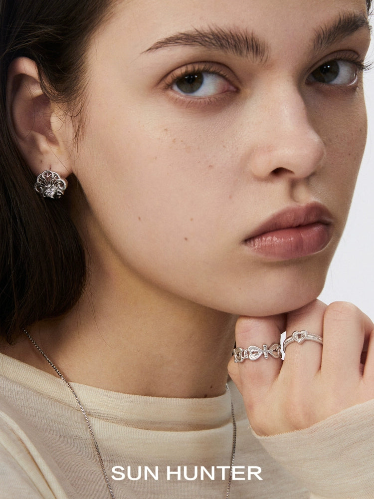 Model wearing SUN HUNTER spring lace keychain earrings with a matching ring for a stylish look