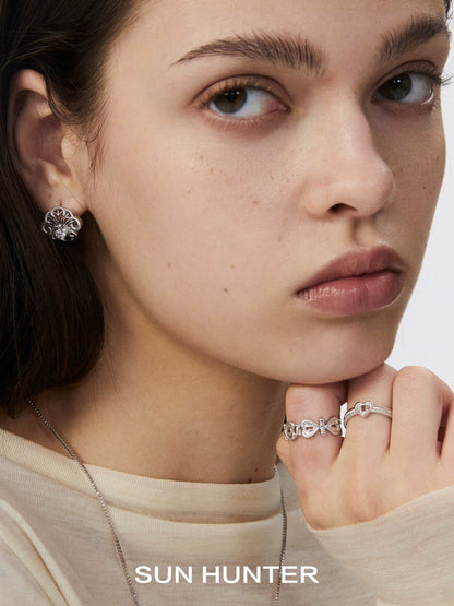 Model wearing SUN HUNTER spring lace keychain earrings with a matching ring for a stylish look