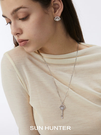 Elegant spring lace keychain earrings by SUN HUNTER styled with a matching pendant necklace