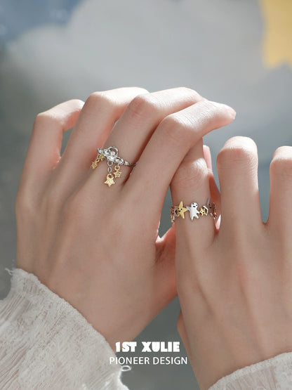 Stylish star shaped silver ring paired with gold accents, displayed on hands with elegant details