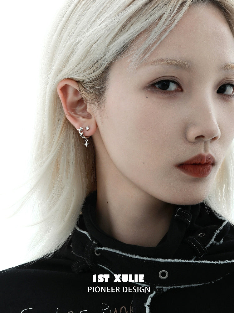 Model wearing star zircon earrings in silver, showcasing a stylish and contemporary jewelry design