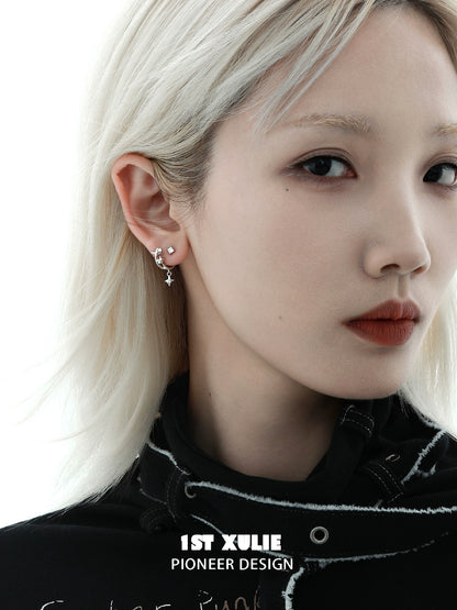 Model wearing star zircon earrings in silver, showcasing a stylish and contemporary jewelry design