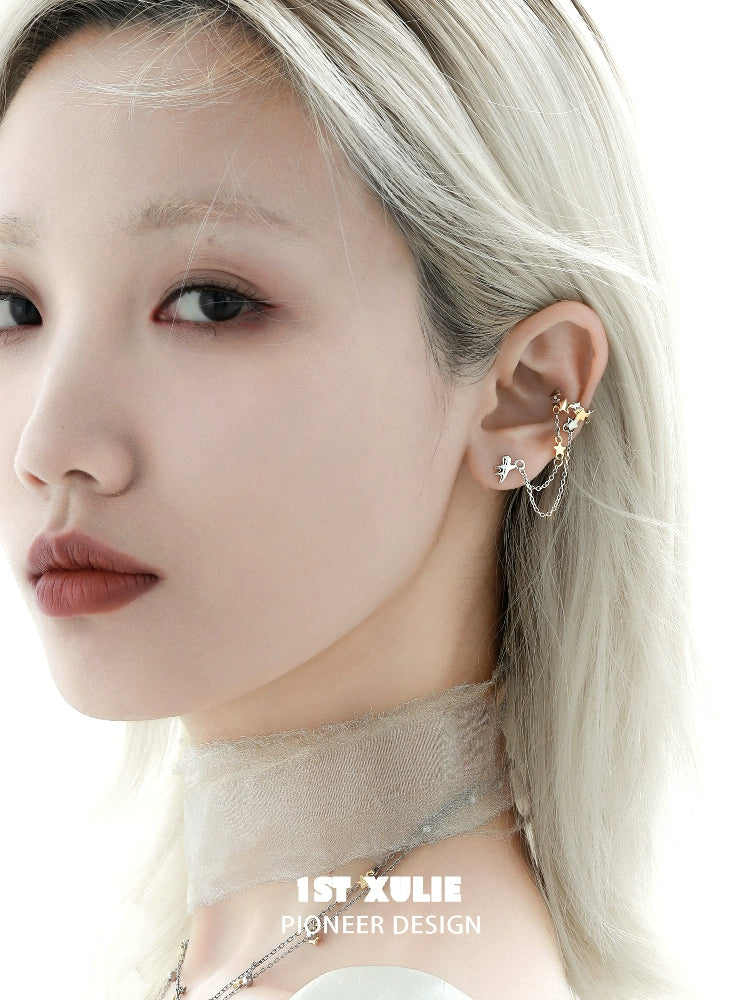 Stylish model wearing a 1STXULIE starlight ear cuff with a delicate design and elegant chain detail