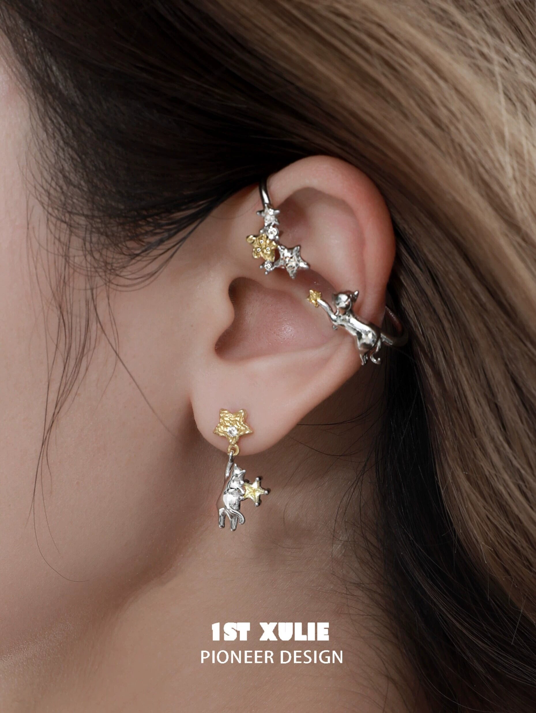 Stylish starry cat ear cuff designed by 1STXULIE with silver and gold accents for a unique look