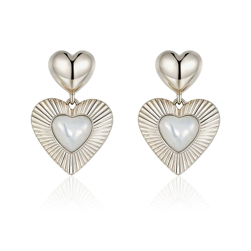 SUN HUNTER heart shaped statement earrings with polished silver and pearl details for a bold look