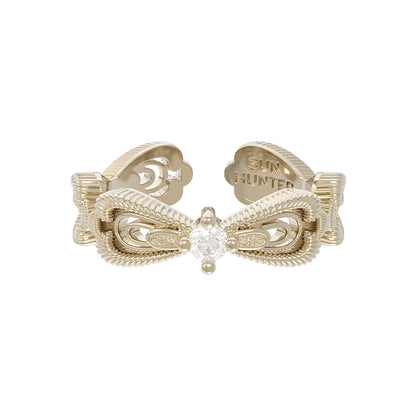 Elegant SUN HUNTER bow lace ring featuring a sparkling center stone and intricate detailing
