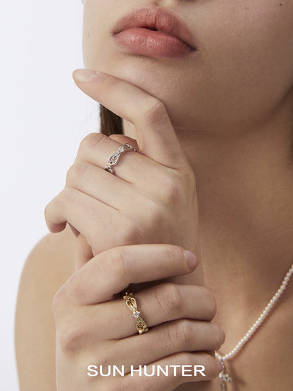 SUN HUNTER Bow Lace Ring in Silver and Gold, elegantly worn on model's fingers