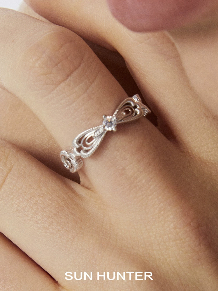 Silver SUN HUNTER bow lace ring featuring intricate lace designs and sparkling accents
