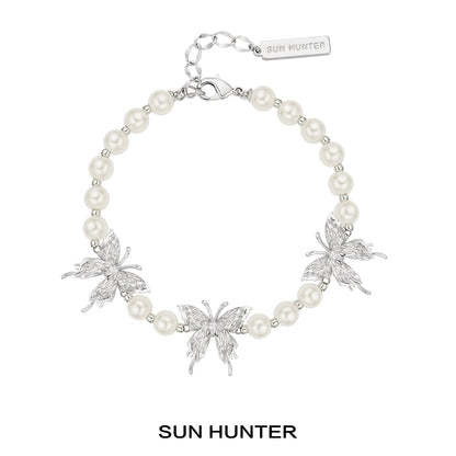 SUN HUNTER butterfly pearl bracelet featuring silver butterflies and elegant pearls