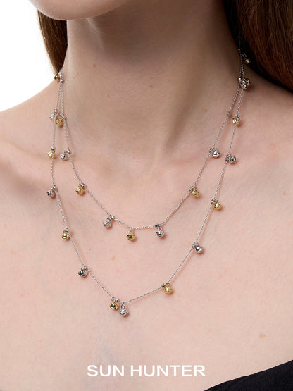 Elegant SUN HUNTER jewelry golden bell pendant necklace for women with layered design and shimmering details