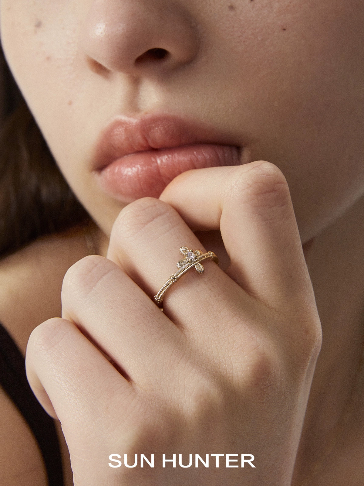 SUN HUNTER lace cross ring displayed on a model's hand with elegant styling for a chic look
