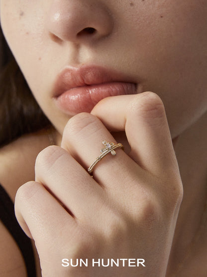 SUN HUNTER lace cross ring displayed on a model's hand with elegant styling for a chic look