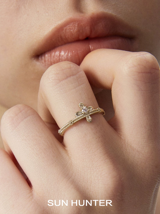 Elegant lace cross ring by SUN HUNTER featuring a delicate design and sparkling gemstone