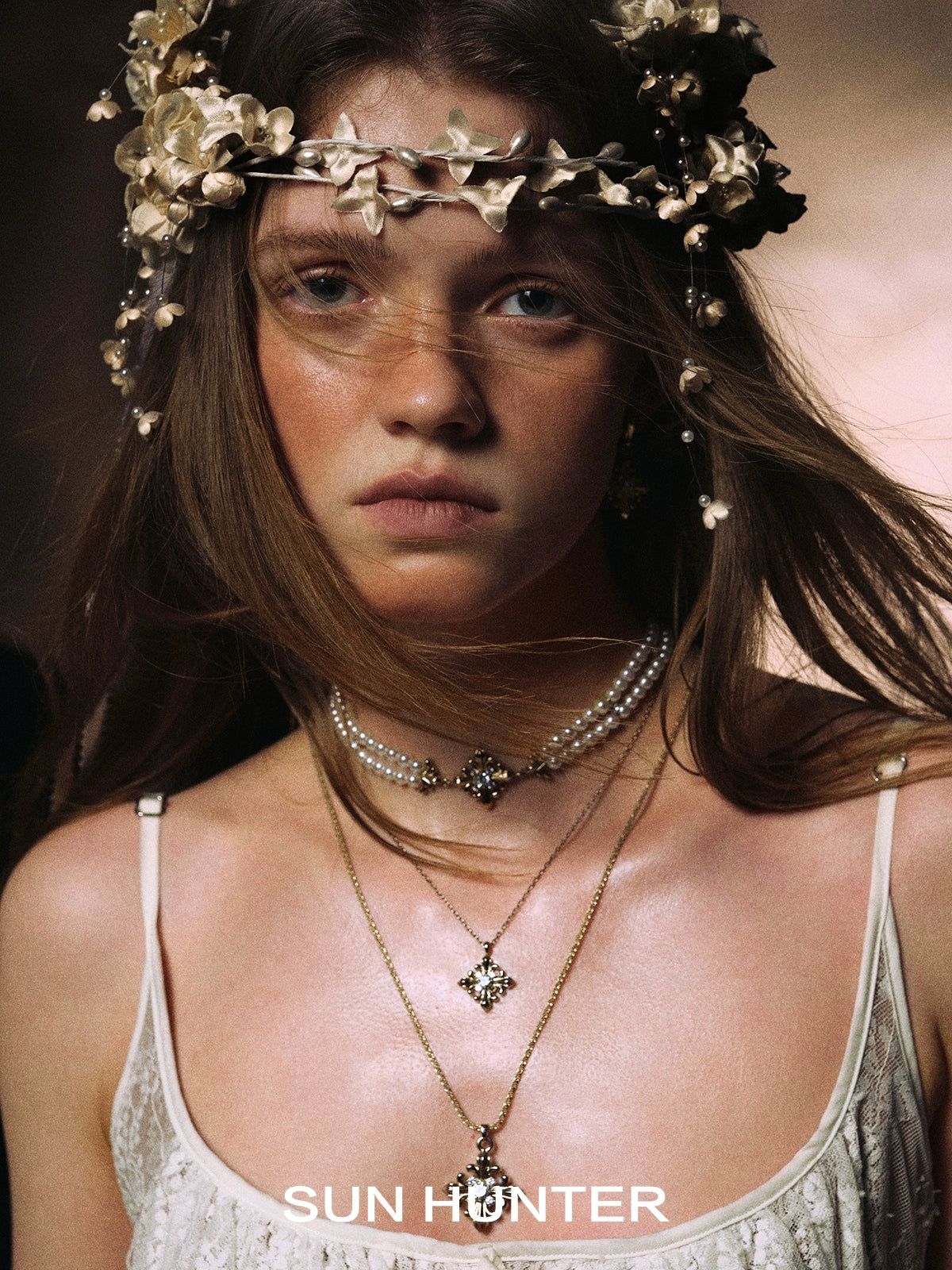 Elegant model wearing Maillard Iris stud earrings set complemented by floral accessories