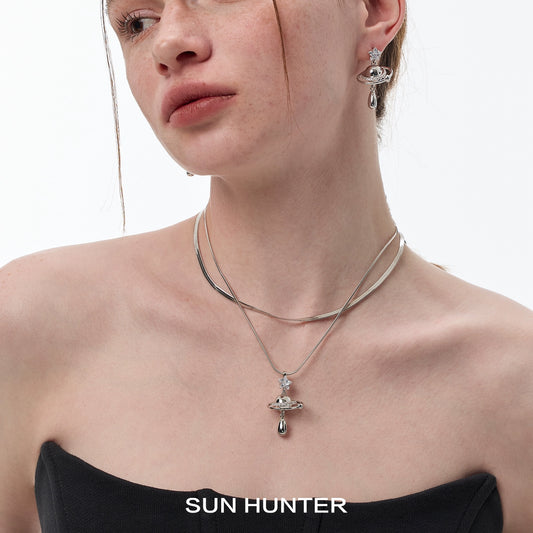 SUN HUNTER universe planet silver necklace with a planet design and shimmering accents