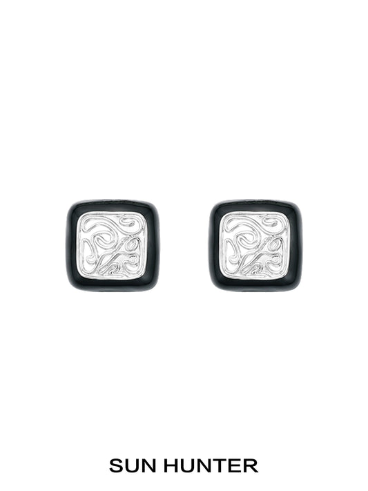 Elegant vintage coin stud earrings by SUN HUNTER with intricate silver designs and a classic look