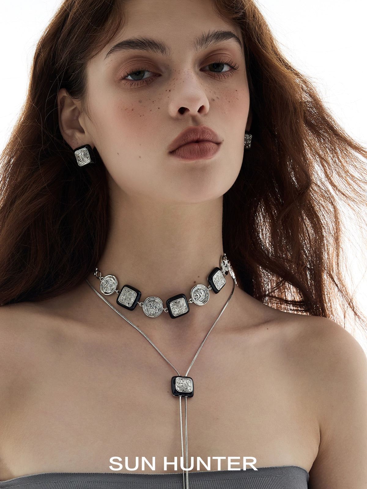 Model wearing vintage coin stud earrings and a matching necklace from SUN HUNTER collection