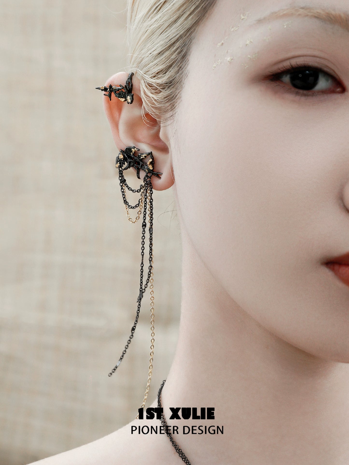 Swallow ear clips from 1ST XULIE featuring intricate design with chains and unique styling