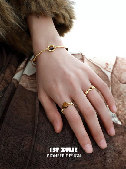 Elegant tiger eye shell silver bracelet featured on a hand wearing a stylish outfit
