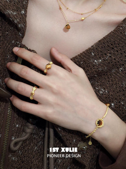 Elegant tiger eye shell silver bracelet displayed on a hand with coordinating gold jewelry
