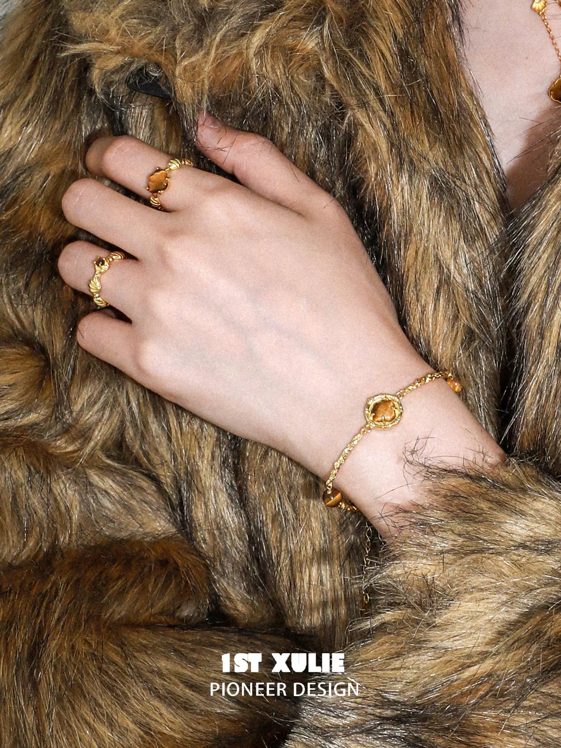 1ST XULIE tiger eye shell silver bracelet showcasing a stylish design on a model's hand